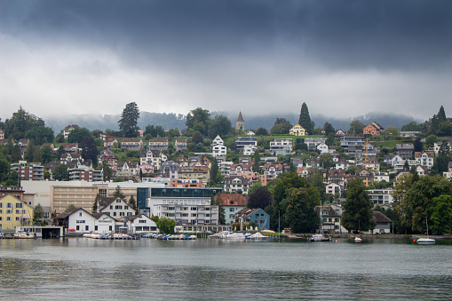 Zurich, Switzerland - August 29, 2021: Riverfront view of the city of Zurich on an overcast day.