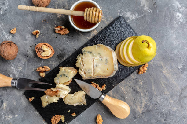 French blue cheese Roquefort, made from sheep milk with walnuts honey and pear. banner, menu, recipe place for text, top view