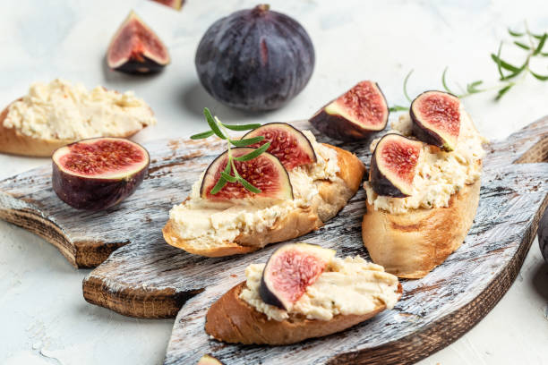 Appetizers. Bruschettas with figs, soft cheese. Delicious breakfast or snack, Clean eating, dieting, vegan food concept. top view