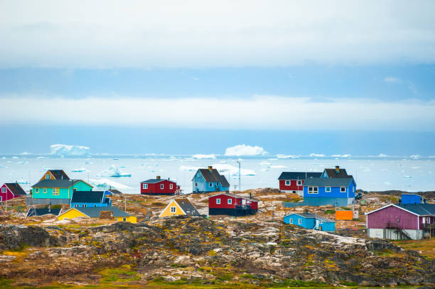 Colorful houses in Saqqaq village, western Greenland. Colorful houses in Saqqaq village and view of the icebergs in Atlantic ocean, western Greenland. Summer landscape greenland stock pictures, royalty-free photos & images