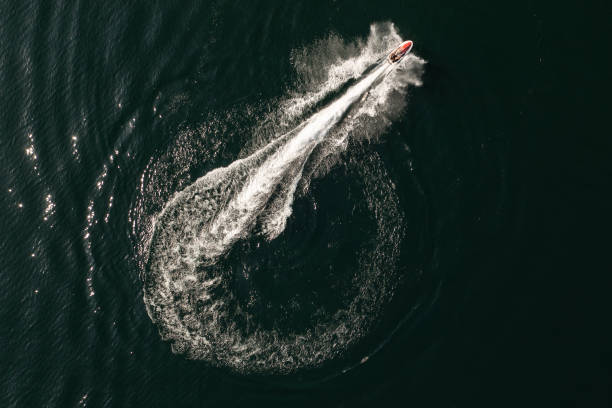 istock Jet-ski with circle wake on a water surface. Top view from drone 1339406464