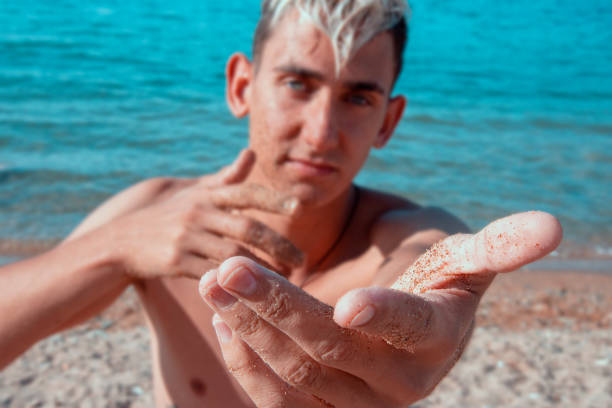 istock Summer and vacation. An attractive guy is resting at the sea. 1339406594