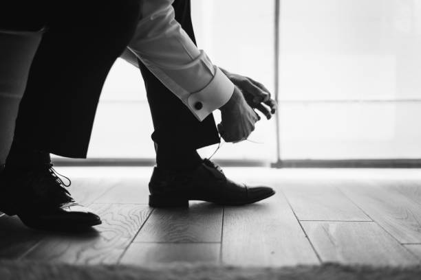 Groom dressing up with classic elegant shoe