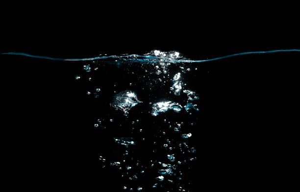 istock Water Surface with Ripple and Bubbles Float Up on Black Background. 1339407991