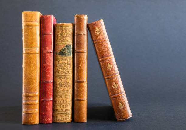 istock Row of old books on dark background 1339410719