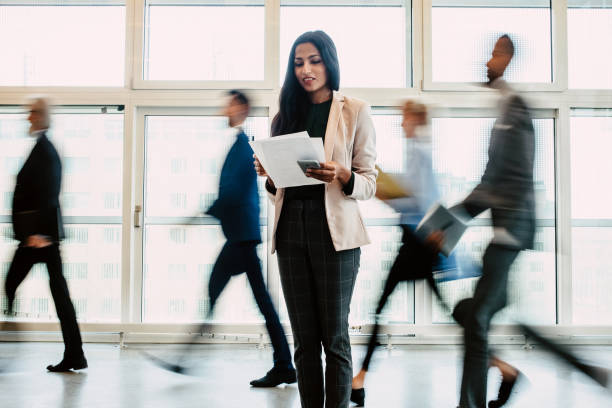 istock Businesswoman reading documents in the corridor 1339417109