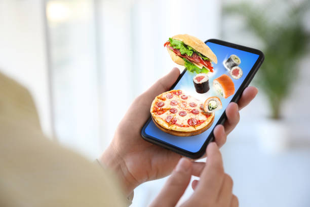 istock Woman using smartphone for ordering food online, closeup. Delivery service during quarantine 1339417147