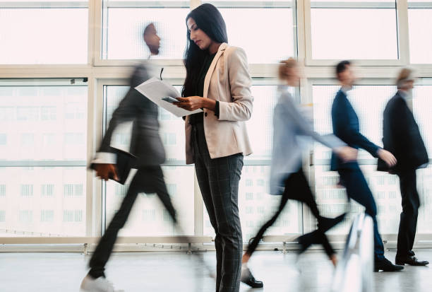 istock Businesswoman reading documents in the corridor 1339417265