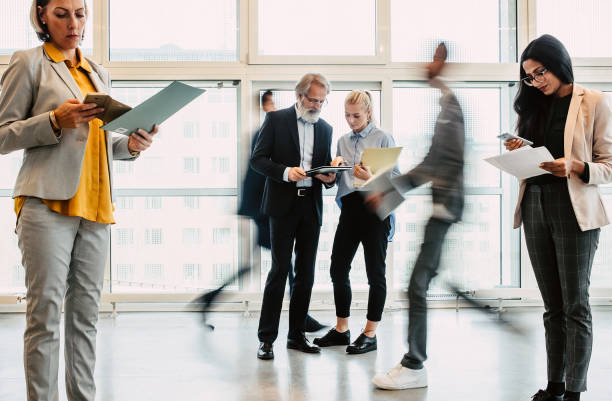 istock Business people discussing in the corridor 1339417289