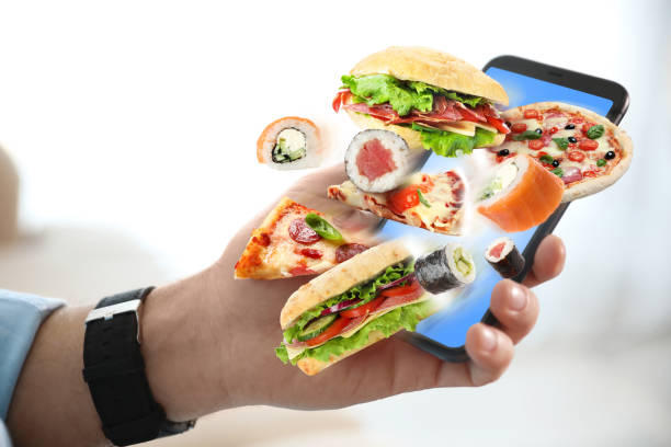 istock Man using smartphone for ordering food online, closeup. Delivery service during quarantine 1339417433
