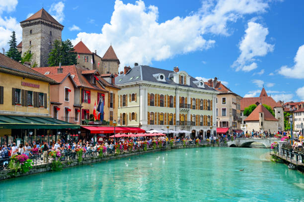 Thiou river in Annecy Thiou river with Palais de l'Ile on background in Annecy, France river restaurant canal annecy stock pictures, royalty-free photos & images