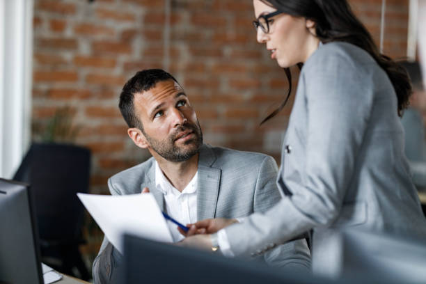 istock Business colleagues talking while working on reports in the office. 1339418480
