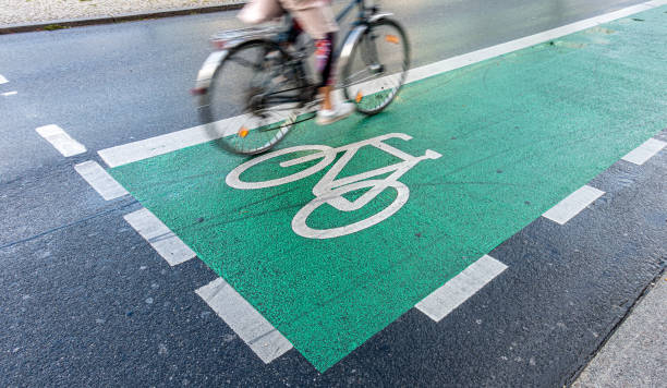istock Low Section Of Man Riding Bicycle On Road 1339419941