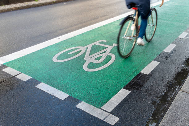istock Low Section Of People Riding Bicycle On Road 1339419945