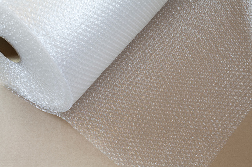 Air cushioning material and bubble wrap material are used to absorb impact and protect the contents of the package.