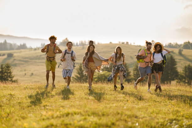 istock Young happy hikers running in spring day on a hill. 1339420409