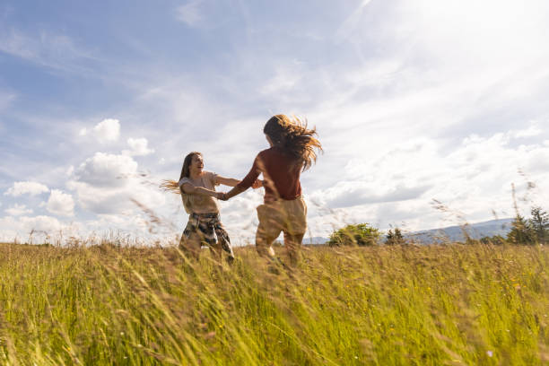 istock Carefree women spinning during spring day in nature. 1339420941