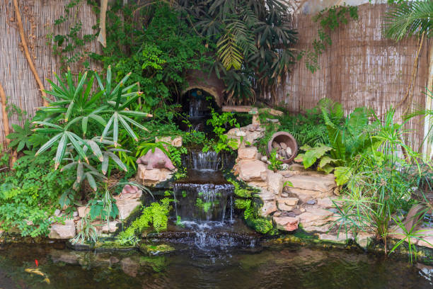 istock View on the decorative waterfall with plants and decorations 1339422563