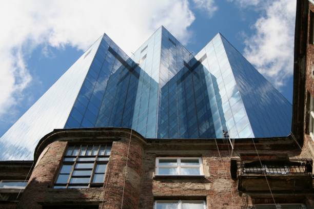 This picture was taken in a pre-II World War courtyard in the very city center of Warsaw, Poland. Many new office buildings have been built after the fall of the communism in 1989, the skyscraper in the background being one of them.