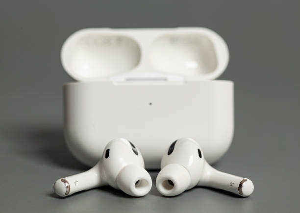 istock Wireless earphones in charging case on grey background 1339425411