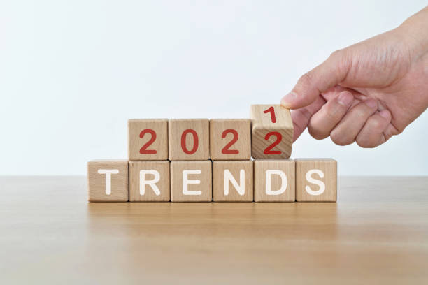 istock Hand turning  blocks from 2021 to 2022 with trends text 1339430148