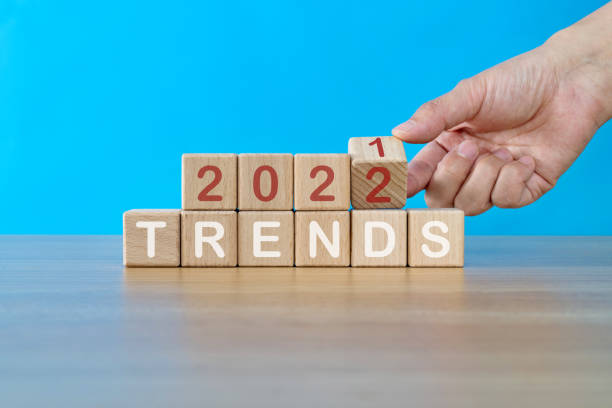 istock Hand turning  blocks from 2021 to 2022 with trends text 1339430172