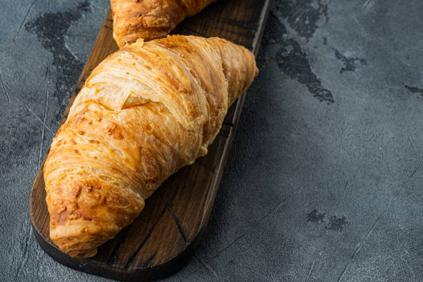 istock Crispy fresh croissants, on gray stone background, with copy space for text 1339431588