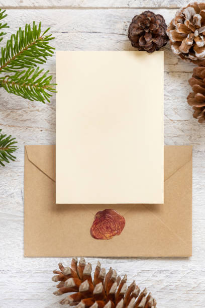 istock Christmas Composition with a card over sealed envelope flat lay. Holiday mockup 1339431627