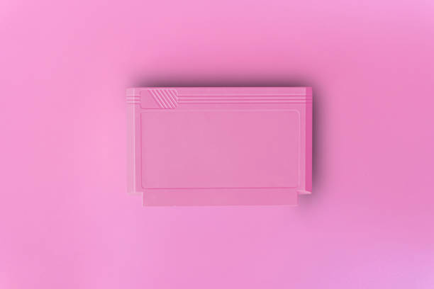 istock 8 bit game cartridge  for retro game console on pink background. Minimal concept. 1339433367