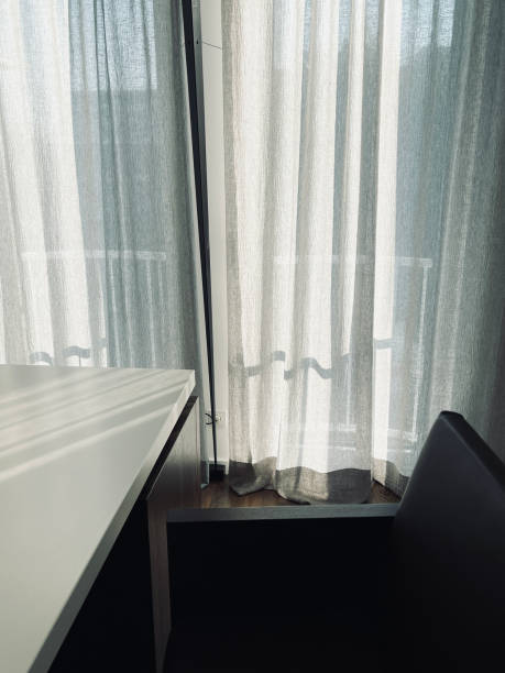 istock Morning sun behind curtains 1339433417