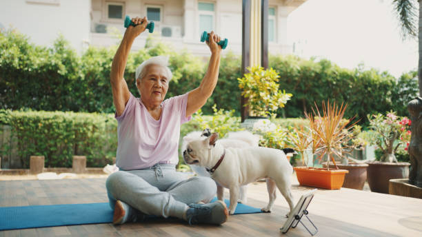active senior woman relaxing in the morning together with a cute dog. - 96 well imagens e fotografias de stock