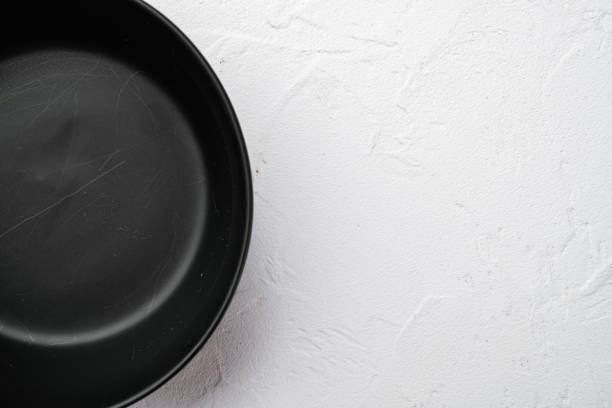 istock Empty black bowl, with copy space for text or food, with copy space for text or food, top view flat lay , on white stone table background 1339435017