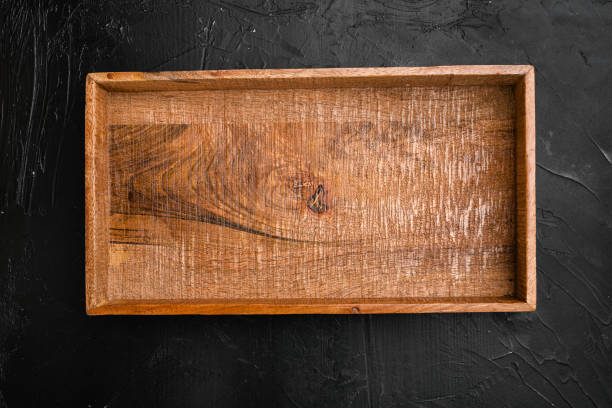 istock Empty dark wooden box with copy space for text or food, top view flat lay , on black dark stone table background 1339435206