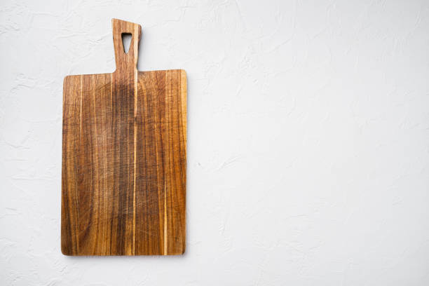 istock Bamboo kitchen cutting board empty for empty for copy space for text or food, top view flat lay , on white stone table background 1339435269