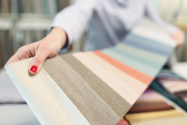 istock Colorful fabric catalog on seamstress or dressmaker work table 1339436856