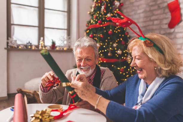 istock Senior couple wrapping Christmas presents 1339438513