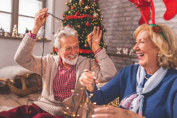 istock Senior couple having fun decorating home for Christmas 1339438808