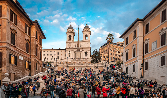 Rome, Italy - December 2 2018: View of the crowded Spanish Steps with the church of the Santissima Trinita dei Monti and the Egyptian obelisk in the background. Photo taken from Piazza di Spagna.
