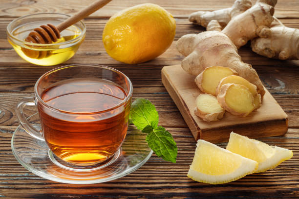 istock Ginger tea with lemon and mint in glass cup on old wooden table. 1339441021