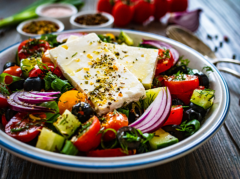 Feta cheese salad on wooden table