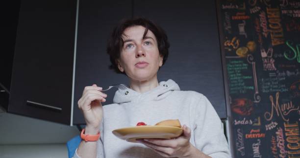 istock Woman is tasting her vegetarian breakfast in domestic kitchen 1339441821