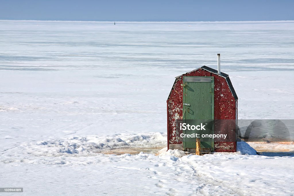 Ice Fishing Shack Rustic ice fishing shack out on the ice off Prince Edward Island, Canada.  Perfect for fishing smelts, a relative of mackeral. Ice Fishing Stock Photo