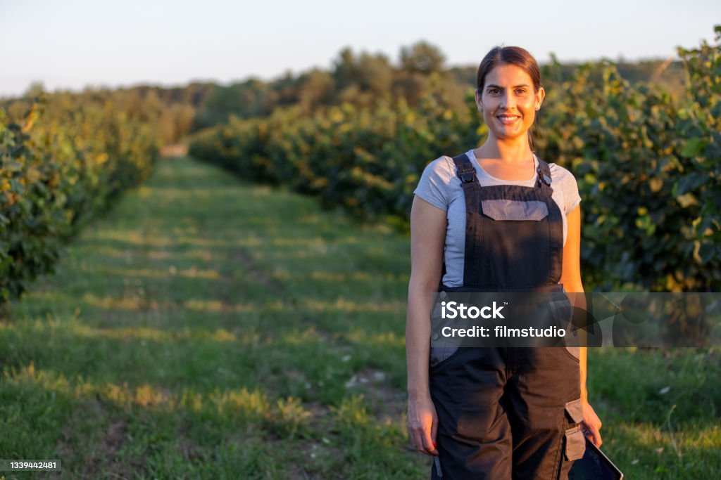 Portrait Of Female Agronomist In The Orchard Portrait of female agronomist in the hazelnut orchard. Women Stock Photo