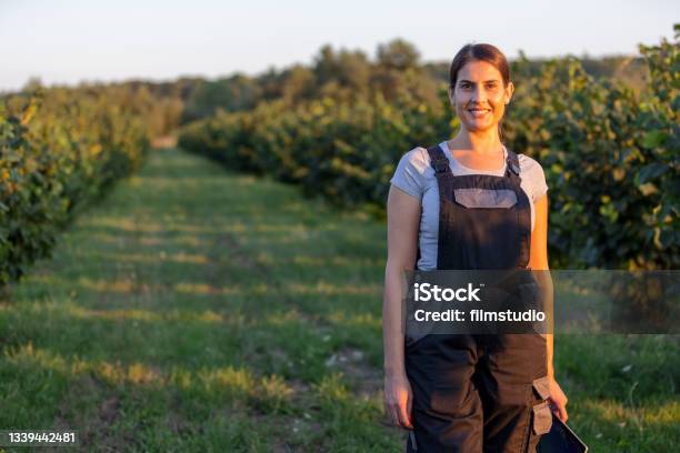 Portrait Of Female Agronomist In The Orchard Stock Photo - Download Image Now - Women, One Woman Only, Farmer