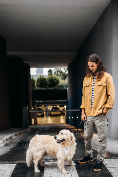 istock Young hipster man posing with his dog 1339445089