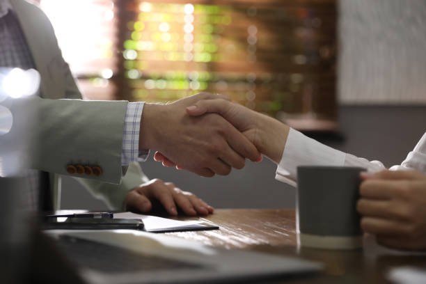 istock Business people shaking hands in office, closeup 1339445432