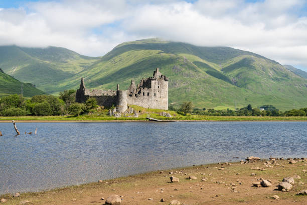 castelo kilchurn na beira do lago awe incluindo as colinas atrás - campbells - fotografias e filmes do acervo