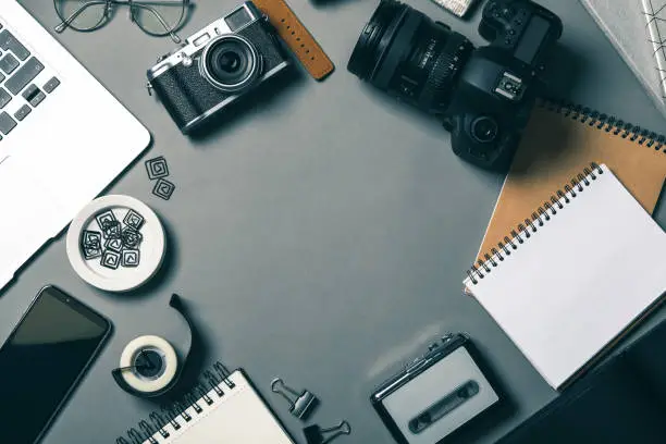 Photo of Flat lay composition with equipment for journalist on grey table, space for text