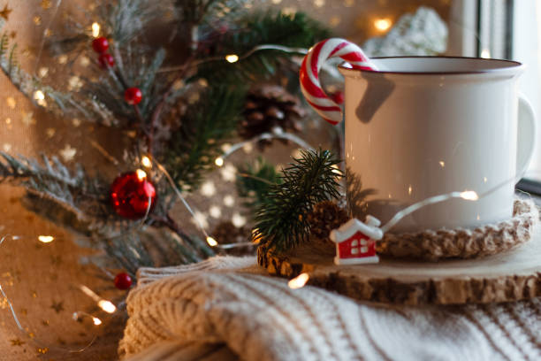 istock Cocoa mug on wooden stand and knitted sweater 1339446624