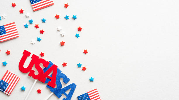 istock American flags, confetti stars and US decorations on white background. Flat lay, top view. Happy Independence Day, American Labor day, US Memorial Day, Columbus day banner design 1339446942